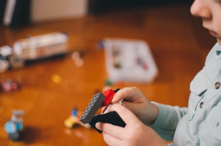 Child playing with toy bricks