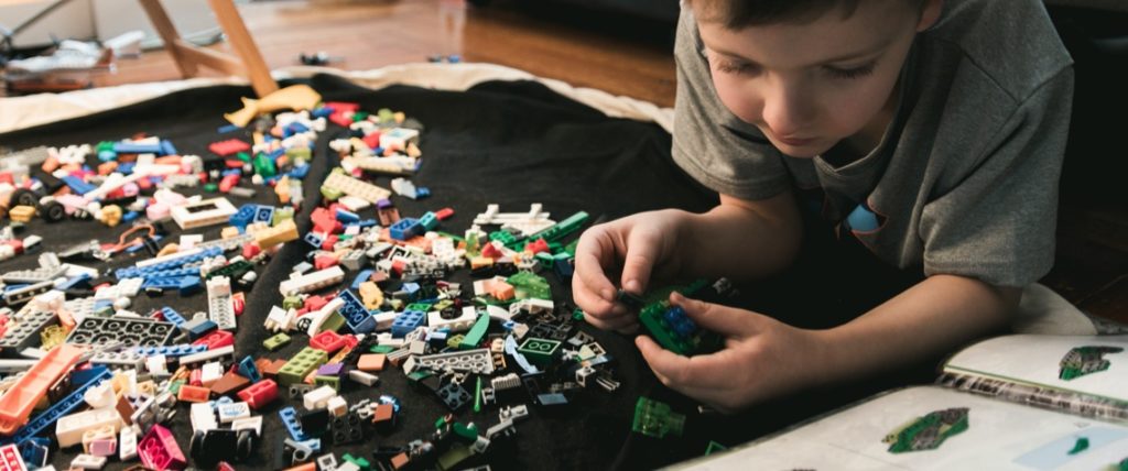 Youth playing with toy bricks